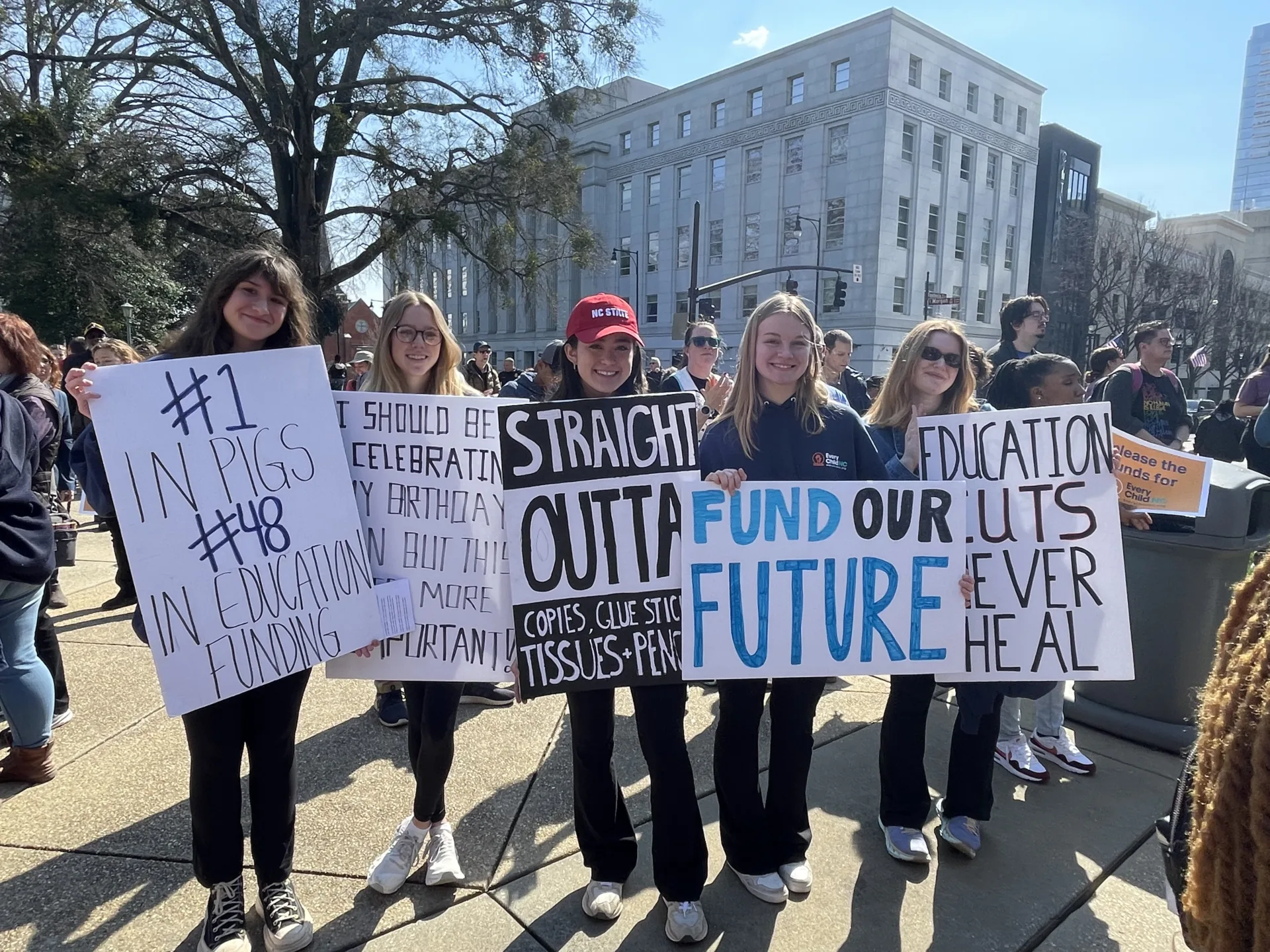 Students standing at a protest with signs